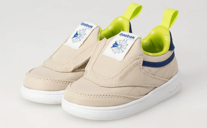 Reebok Toddler Club C IV Slip On Sneakers on Biege Background Reebok Toddler Club C IV Slip On Sneakers on Biege Background