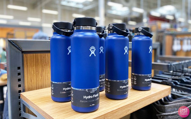 Five Royal Blue Hydro Flasks on a Shelf inside a Store