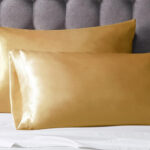 Set of 2 Gold Satin Pillow Cases Queen on a Bed