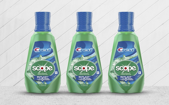 Three Counts of Crest Scope Outlast Mouthwash Fresh Mint Bottles on a Table