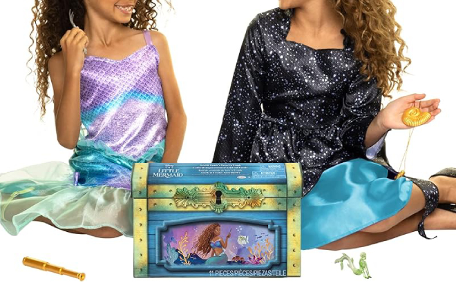 Two Girls Wearing Ariel and Ursula Dresses and Holding Accessories Included in the Dress Up Tunk Set