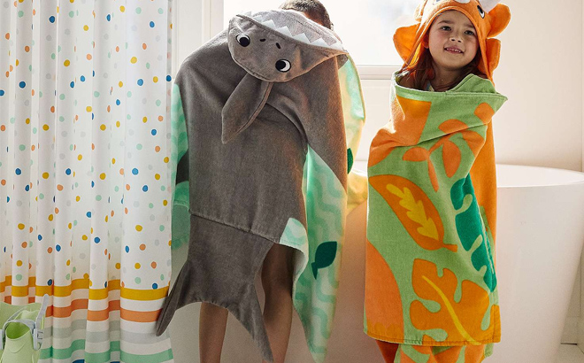 Two Kids Wearing Different Styles of The Big One Kids Hooded Bath Towel