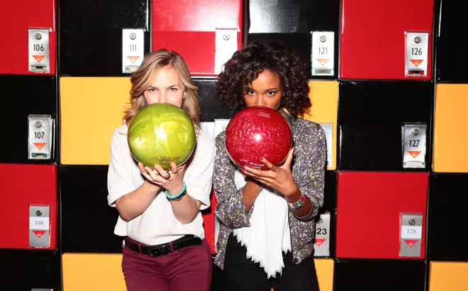 Two Women Each Holding a Bowling Bowl Two Women Each Holding a Bowling Bowl