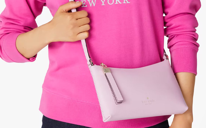 Woman is Wearing Kate Spade Sadie Crossbody in Blossom Pink Color Woman is Wearing Kate Spade Sadie Crossbody in Blossom Pink Color