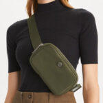 Woman is Wearing Tory Burch Virginia Belt Bag in Olive Green Color
