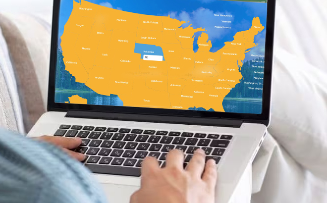 a Person Searching US States on a Laptop