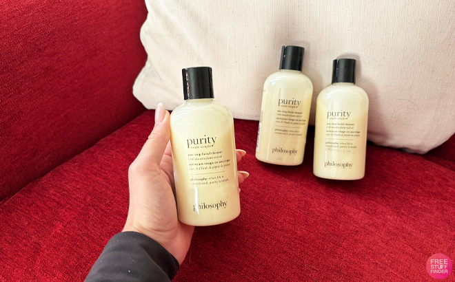 a person holding a philosophy purity made simple one step facial cleanser