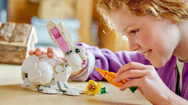 girl playing with LEGO Creator 3 in 1 White Rabbit Animal Toy Building Set