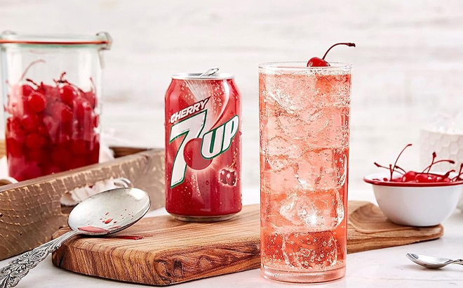 7UP Cherry Flavored Soda in a Can Next to a Glass on a Table