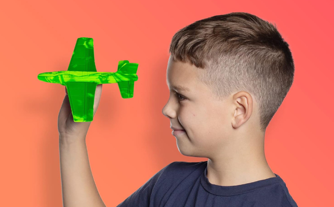 A Boy Holding a Foam Airplane