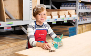 A Child Holding a Playful Garden Cart Planter from Lowes