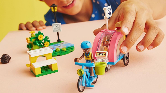 A Child Playing with LEGO Friends Dog Rescue Bike Building Set