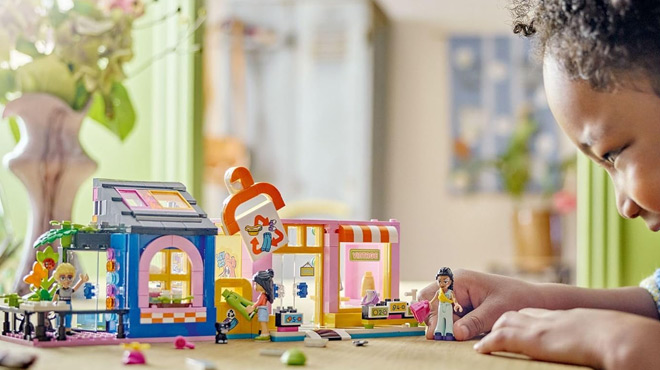 A Child Playing with LEGO Friends Vintage Fashion Store Toy