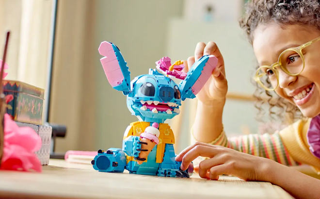 A Child Playing with Stitch Lego Figure
