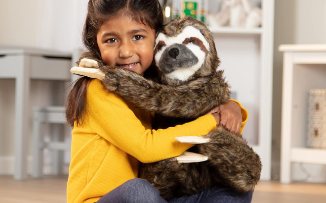 A Girl Hugging a Melissa Doug Lifelike Sloth Plush