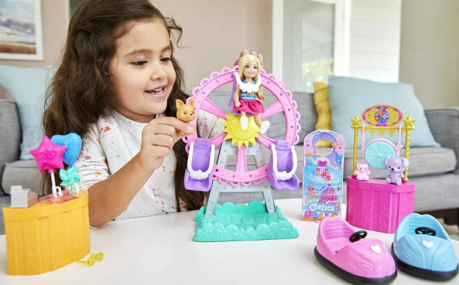 A Girl Playing With Barbie Club Chelsea Carnival Playset