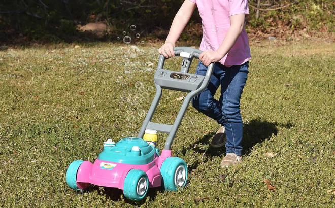 A Girl Playing with Bubble N Go Toy Lawn Mower Toy