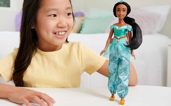 A Kid Holding Mattel Disney Princess Jasmine Fashion Doll
