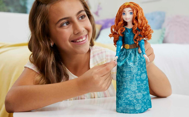 A Kid Holding Mattel Disney Princess Merida Fashion Doll