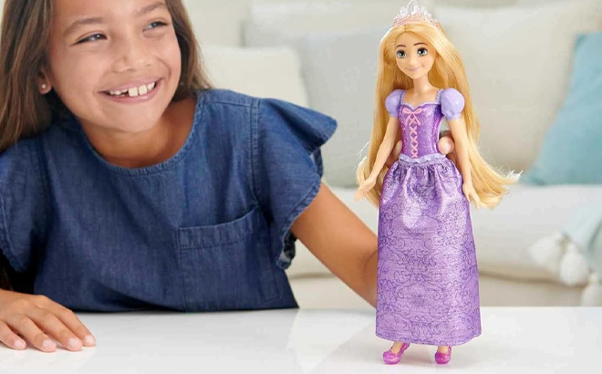 A Kid Holding Mattel Disney Princess Rapunzel Fashion Doll