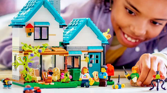 A Kid Playing with LEGO Creator 3 in 1 Cozy House Building Kit