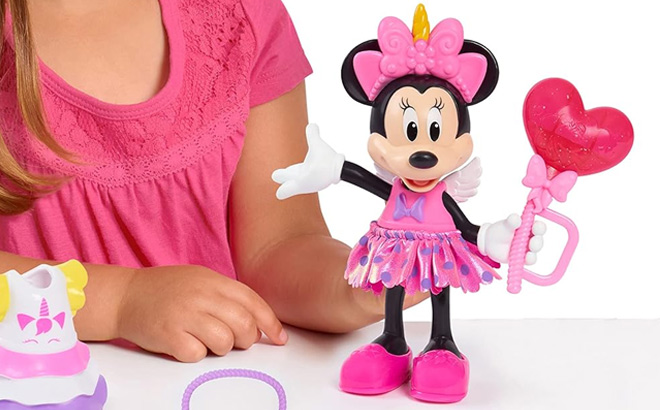 A Kid is Holding Minnie Mouse Doll