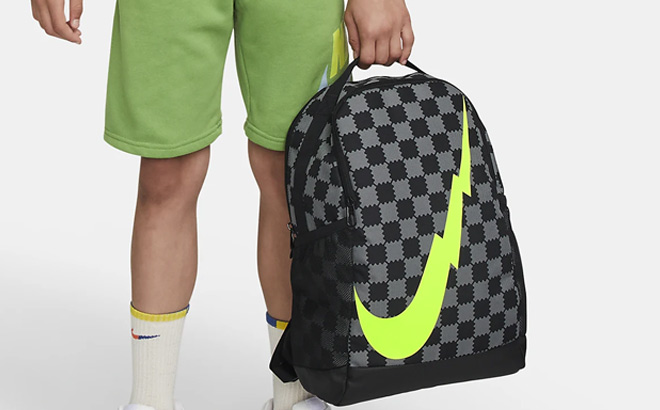 A Kid is Holding Nike Brasilia Kids Backpack A Kid Holding Nike Brasilia Kids Backpack