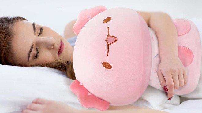 A Lady Sleeping Hugging a Mewaii 8 inch Mushroom Plush Pink Axotl while Asleep