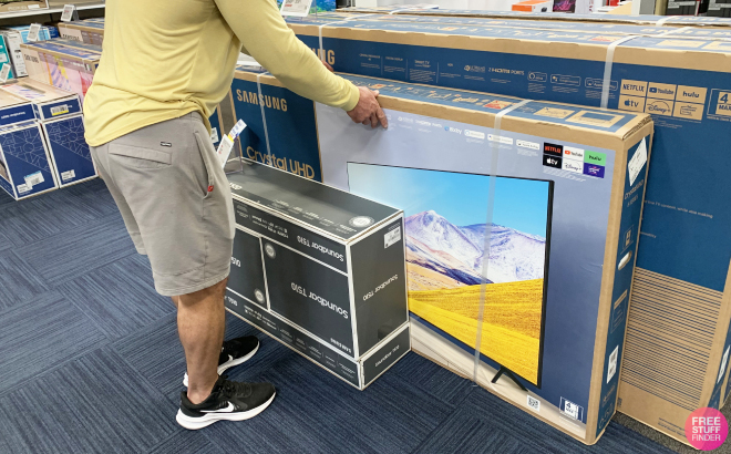 A Man Looking at Samsung TVs in a Store