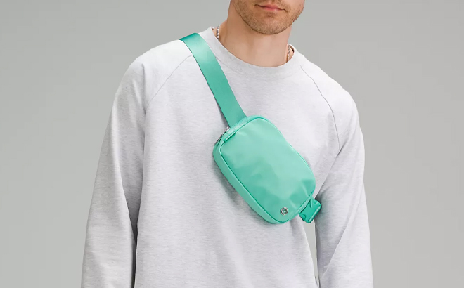 A Man Wearing Lululemon Everywhere Belt Bag in Paradise Green
