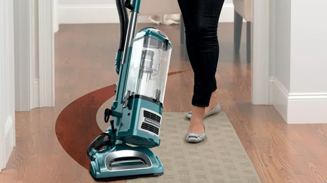 A Person Cleaning her Living Room Using a Shark Navigator Lift Away XL Multi surface Vacuum