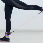 A Person Exercising Using Ankle Resistance Bands with Cuffs