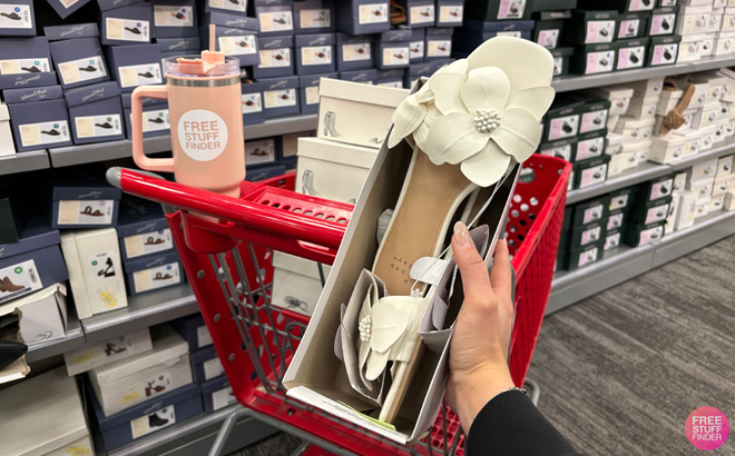 A Person Holding A New Day Womens Alyssa Floral Slide Sandals in Front of a Cart and a Free Stuff Finder Bottle