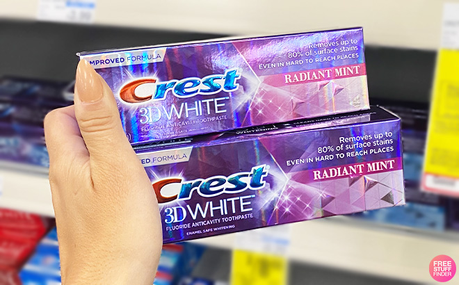 A Person Holding Crest Toothpastes