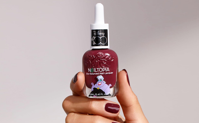 A Person Holding Disney Villains Nailtopia Nail Polish in Dark Purple Ursula