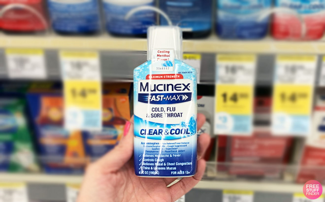 A Person Holding Mucinex Medicine inside a Store