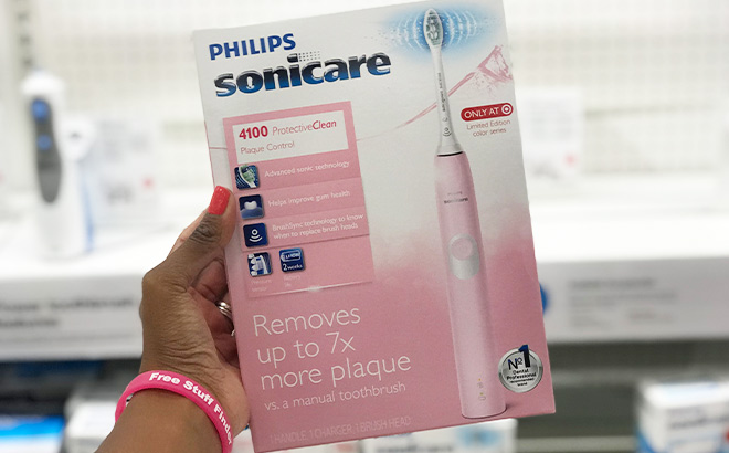 A Person Holding Philips Sonicare 4100 Plaque Control Rechargeable Electric Toothbrush A Person Holding Philips Sonicare 4100 Plaque Control Rechargeable Electric Toothbrush