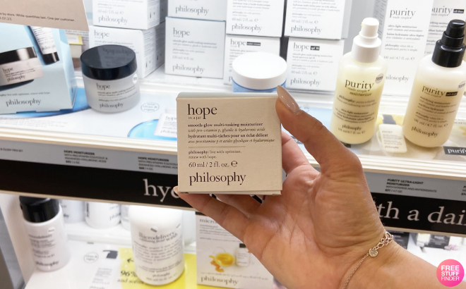 A Person Holding Philosophy Hope in a Jar Smooth Glow Multi Tasking Moisturizer