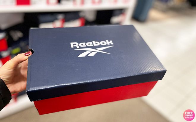 A Person Holding Reebok Shoe Box