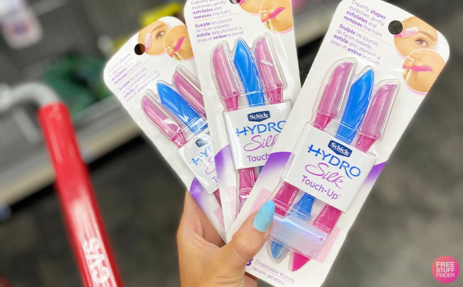 A Person Holding Three Schick Hydro Silk Touch Up Dermaplaning Tool 3 Count at a Store