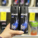 A Person Holding Two Bottles of Axe Mens Body Spray Deodorant
