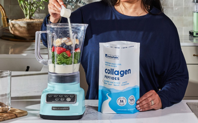 A Person Holding a Bag of NativePath Collagen Peptides and Adding a Scoop to a Blender