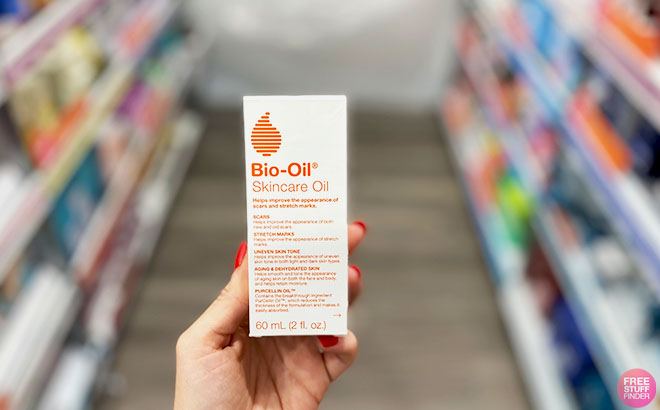 A Person Holding a Bio Oil Skincare Oil Box in the SUpermarket aisle
