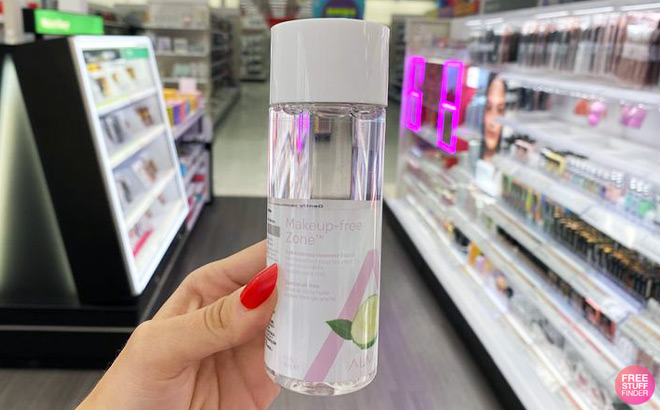 A Person Holding a Bottle of Makeup Remover inside a Store
