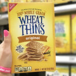A Person Holding a Box of Wheat Thins Crackers in Original Flavor