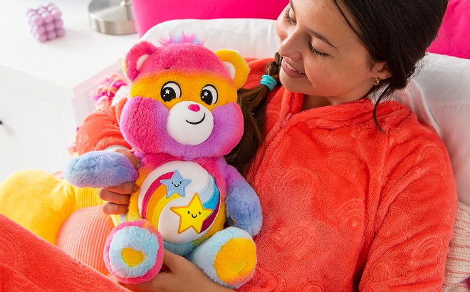 A Person Holding a Care Bears Dare to Tie Dye 14 Inch Plush