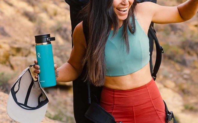 A Person Holding a Hydro Flask 20 Ounce Coffee Cup with Flex Sip Lid While Hiking