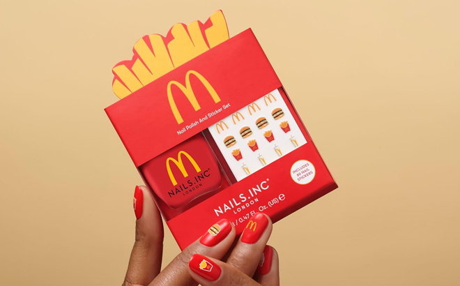 A Person Holding a Nails Inc x McDonald Nail Polish with Stickers