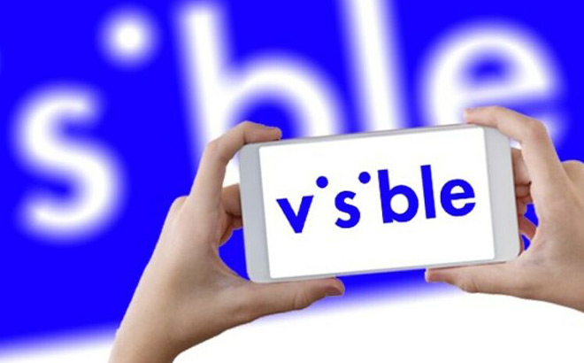 A Person Holding a Phone with Visible on the Background