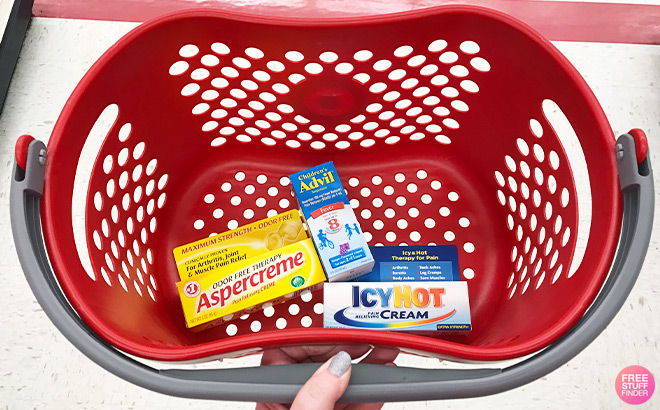 A Person Holding a Shopping Basket with Medicine in it